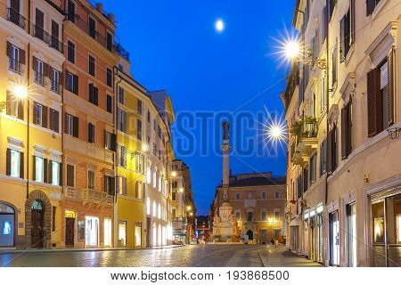 The Column of the Immaculate Conception depicting the Blessed Virgin Mary, on Piazza Mignanelli during morning blue hour, Rome, Italy.