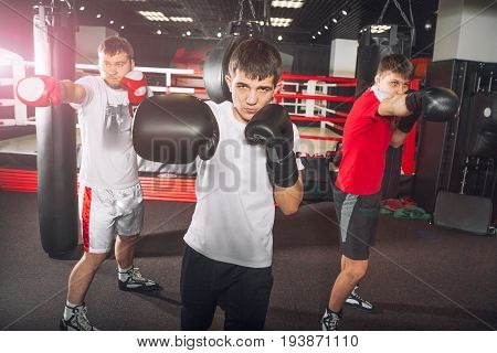 A young boxing coach teaches men in a fight club
