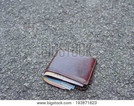 wallet with money drop on the street