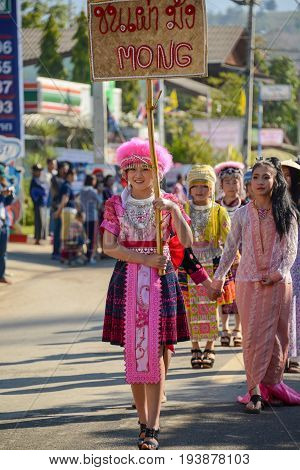 CHIANGMAI THAILAND - JANUARY 25 2015: Hill Tribe girl holding board of the indigenous name in the parade of 22nd Traditional Skirt Fabric and The Indigenous Product and Culture Festival in Mae Chaem of Chiangmai Thailand