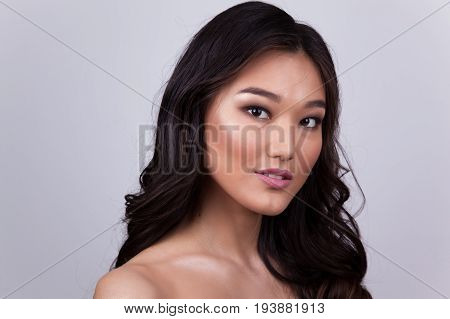 Portrait of a beautiful asian woman with naked shoulders.