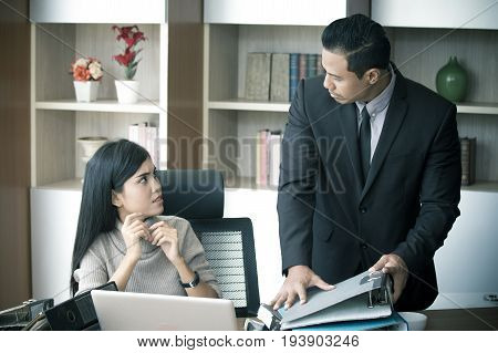 Unfair Boss Giving Assistant Woman A Lot Of Work At Ofiice Place.