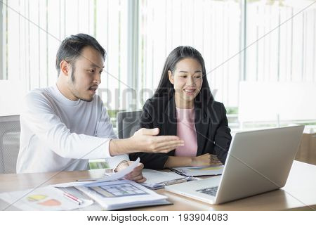 Asian Man Present Project For Woman At Office Place People Working Concept 20-30 Years Old.