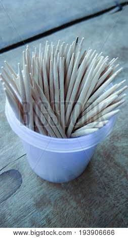 abstract wooden tooth picks on wood background