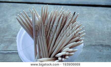 abstract wooden tooth picks on wood background