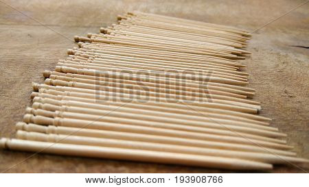 tooth picks abstract composition background in wood