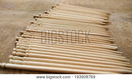 tooth picks abstract composition background in wood