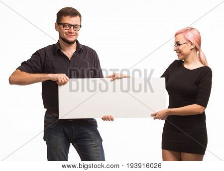 Young jocular couple portrait of a confident businessman showing presentation, pointing paper placard background. Ideal for banners, registration forms, presentation, landings, presenting concept.