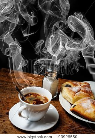 a cup of coffee and cakes on old wooden table - breakfast