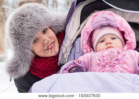 Beautiful Mom And Nice Baby Outdor In A Winter