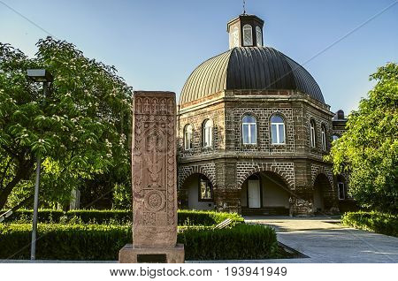Ancient khachkar in front of the building of the Gevorkyan Theological Academy in Echmiadzin