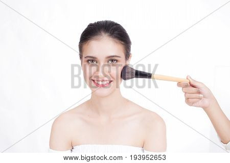 Makeup Artist Applies Brushed At Woman Face. Beautiful Woman Face. Perfect Makeup, Isolated On White
