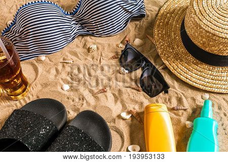 Summer bikini and accessories stylish beach set, Beach bikini summer outfit and sea sand as background, Top View, Concept. Copy space. Still life mockup flat lay