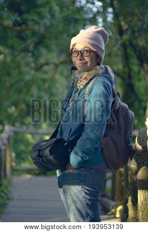 Female tourists stand on a wooden walkway study wild and natural.
