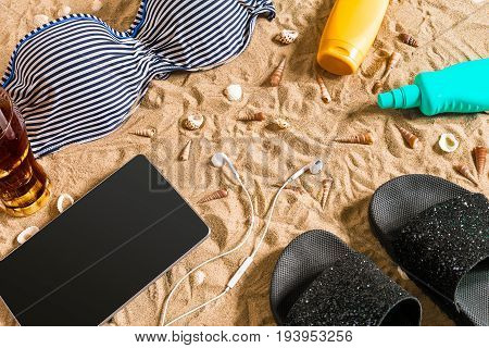 Summer bikini and accessories stylish beach set, Beach bikini summer outfit and sea sand as background, Top View, Concept. Copy space. Still life mockup flat lay
