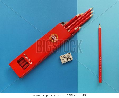 NACHOD, CZECH REPUBLIC - JUNE 29, 2016: Drawing pencils in box, one single pencil and eraser on blue papers, products of Koh-i-noor, the Czech manufacture, made in Ceske Budejovice