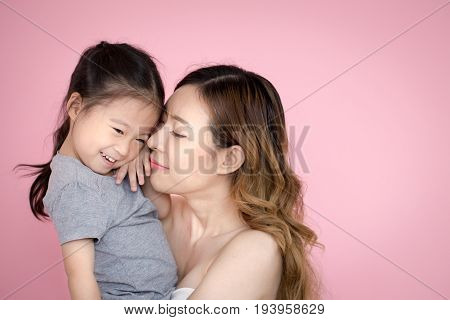 Woman Hodling Kid With Happy Emotion Isolated On Pink Background.