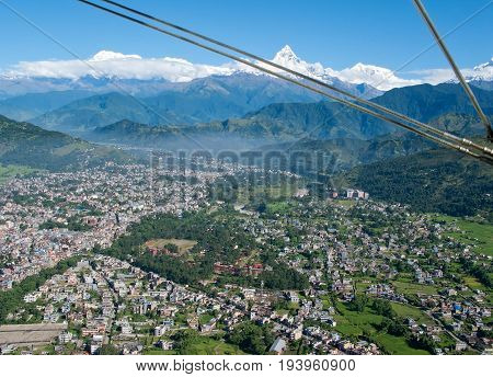 POKHARA, NEPAL. Flight on a hang glider (deltaplan). Shooting Pokhara and Green rice terraces of the Himalayas from the height of bird flight.