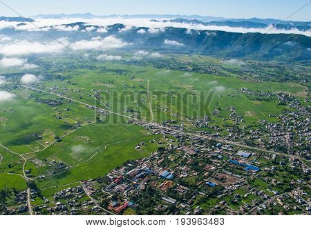 POKHARA, NEPAL. Flight on a hang glider (deltaplan). Shooting Pokhara and Green rice terraces of the Himalayas from the height of bird flight.