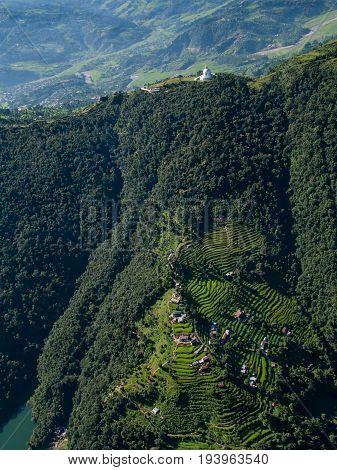 POKHARA, NEPAL. Flight on a hang glider (deltaplan). Shooting Pokhara and Green rice terraces of the Himalayas from the height of bird flight.