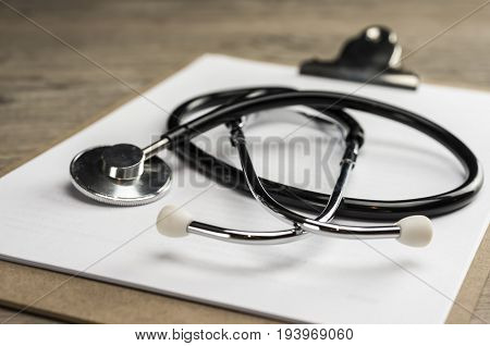 Close up shot of a stethoscope on a cilp pad