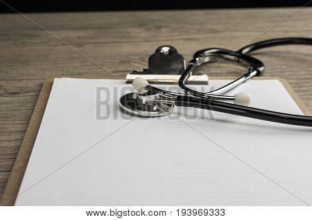 Close up shot of a stethoscope on a cilp pad