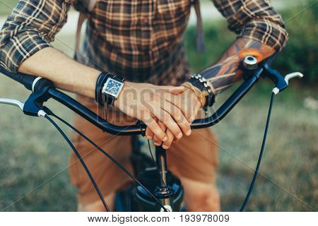 Unrecognizable Young Man Put His Hands On The Wheel Of A bicycle Destination Relaxation Resting Concept