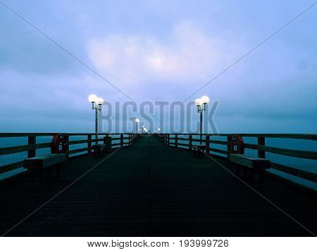 Long Touristic Mole Within Autumn Misty Morning. Wet And Slippery Wooden Floor,