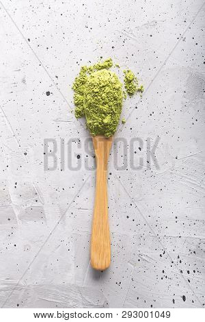Green Tea Matcha In A Spoon On Concrete Surface. Close Up Shot
