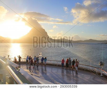 Bora Bora, French Polynesia - September 28, 2012 : Cruise Ship Passengers Watch The Sunrise Over Bor
