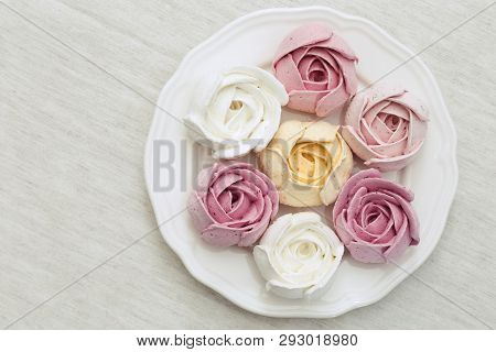 Colored Zephyr In The Shape Of Flowers On A White Plate. Beautiful And Delicious Low Calorie Dessert