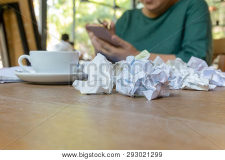 Wwoman Hand Using Cell Phone Working After Hours With Crumpled Paper On Table.