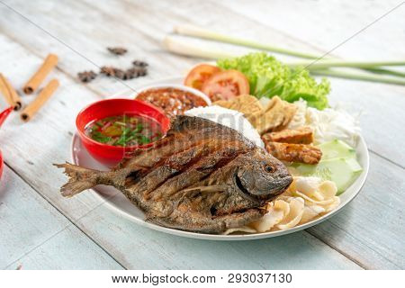 Fried pomfret fish and rice, popular traditional Malay or Indonesian local food.