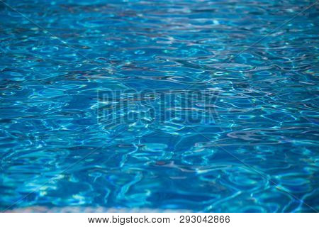 Blurred Water Texture In Summer Pool Close Up.