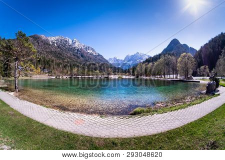 Footpath Along Lake Jasna With Mountains Razor And Prisojnik On The Horizont In Slovenia