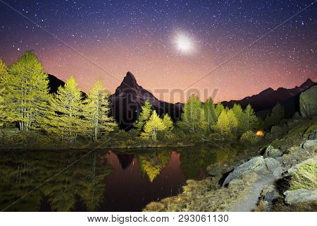Autumn Larches On The Background Of The Matterhorn And Autumn In The Alps. The Clear Water Of The Mo