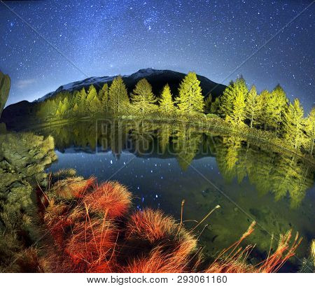 Autumn Larches On The Background Of The Matterhorn And Autumn In The Alps. The Clear Water Of The Mo