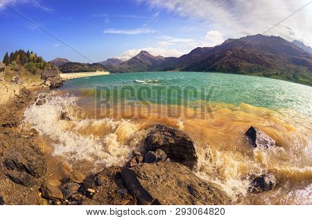 Mountains And Lake Roselend  With A Dike