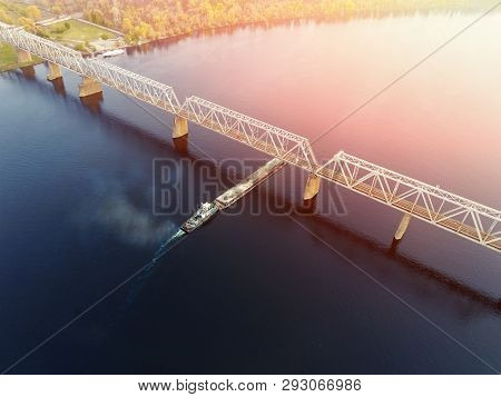 Scenic Aerial Cityscape Of Kiev And River Dnipro At Sunset. Tugboat Supporting Barge With Sand Bulk 