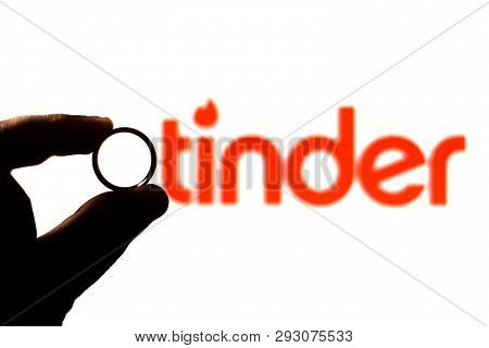 April 2, 2019, Brazil. Man Safe Wedding Ring. Tinder Logo In The Background. People Use Tinder For R