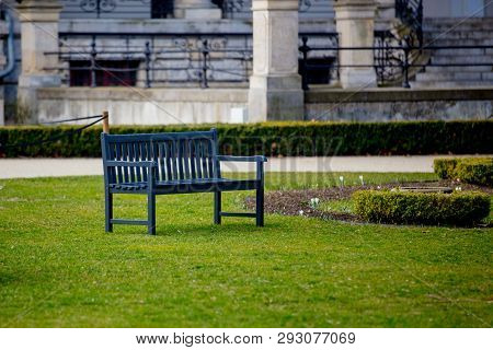 Gray Bench In French Style In A Greenpark. Spring Time Season