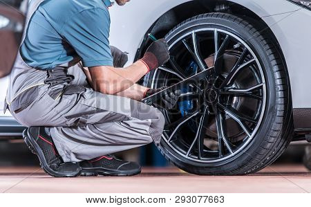 Tires And Wheels Inspection By Professional Automotive Technician In The Certified Auto Service.