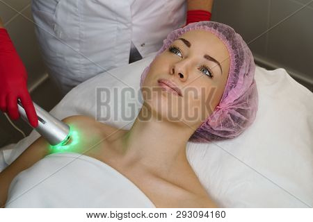 Ultrasound Chromotherapy. Hardware Cosmetology. Beautician Carries Out Procedure For Tightening Skin