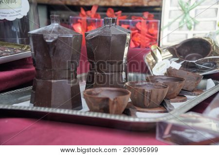 Moka Pot Coffee Maker Make From Chocolate In Vintage Style On Candies Background.