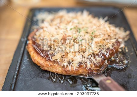 Okonomiyaki; Tranditional Japanese Food Style Handmade And Cut On A Iron Plate Ready To Serve And Ea