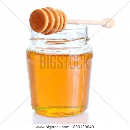 Yellow Liquid Honey In Glass Isolated On White