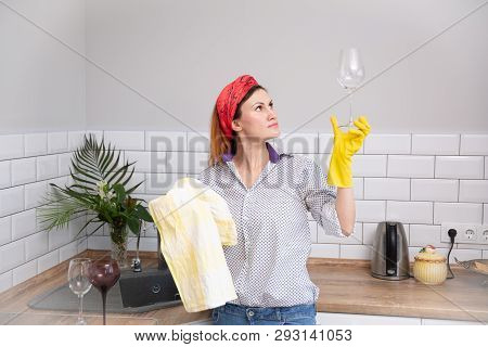 Woman Cleaning Or Ruges Glass In The Kitchen.