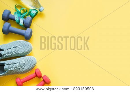 Sport And Fitness Equipment, Dumbbells, Fitness Shoes, Measuring Tape On Punchy Yellow.