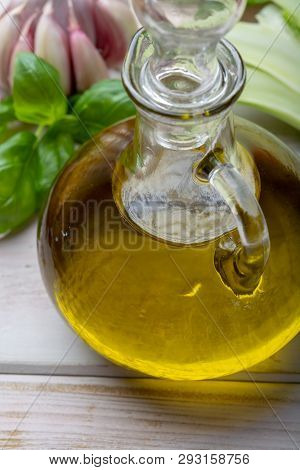Virgin Natural Olive Oil Is Glass Bottle, Served With Traditional Mediterranean Food