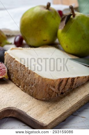 Piece Of French Cheese Tomme De Brebis Made From Sheep Milk Served As Dessert With Fresh Figs And Pe